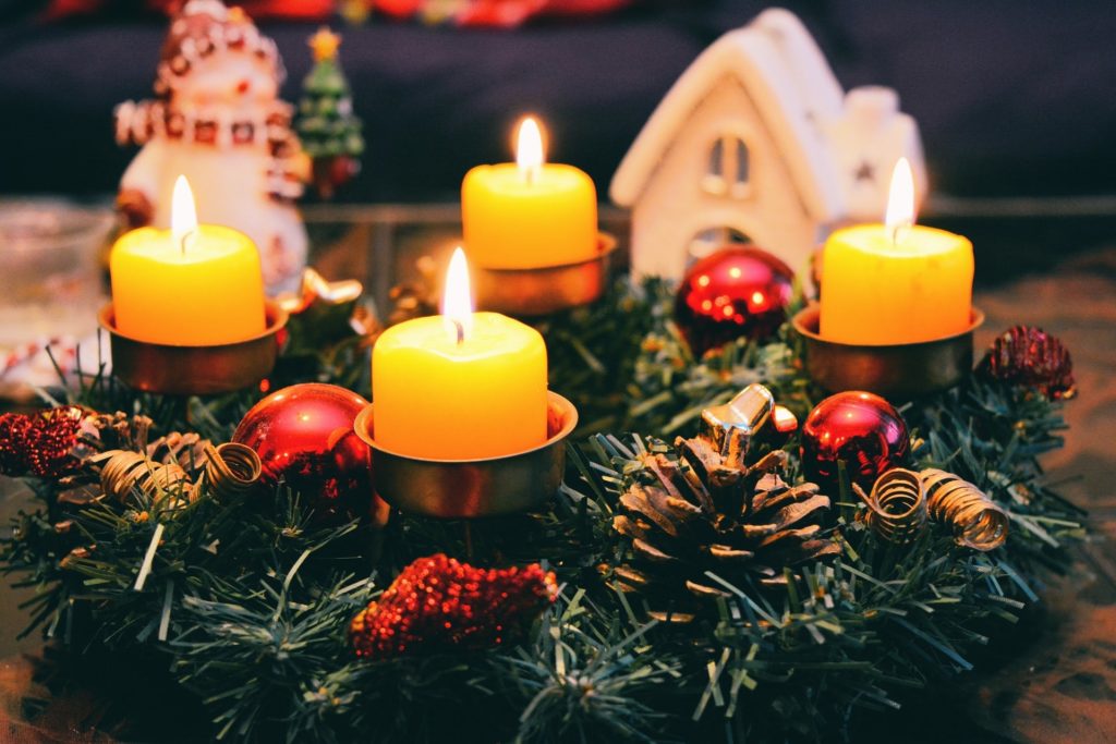 candles on a holiday wreath