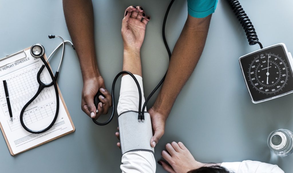The doctor using blood pressure machine for the patient in hospital at Abbotsford BC