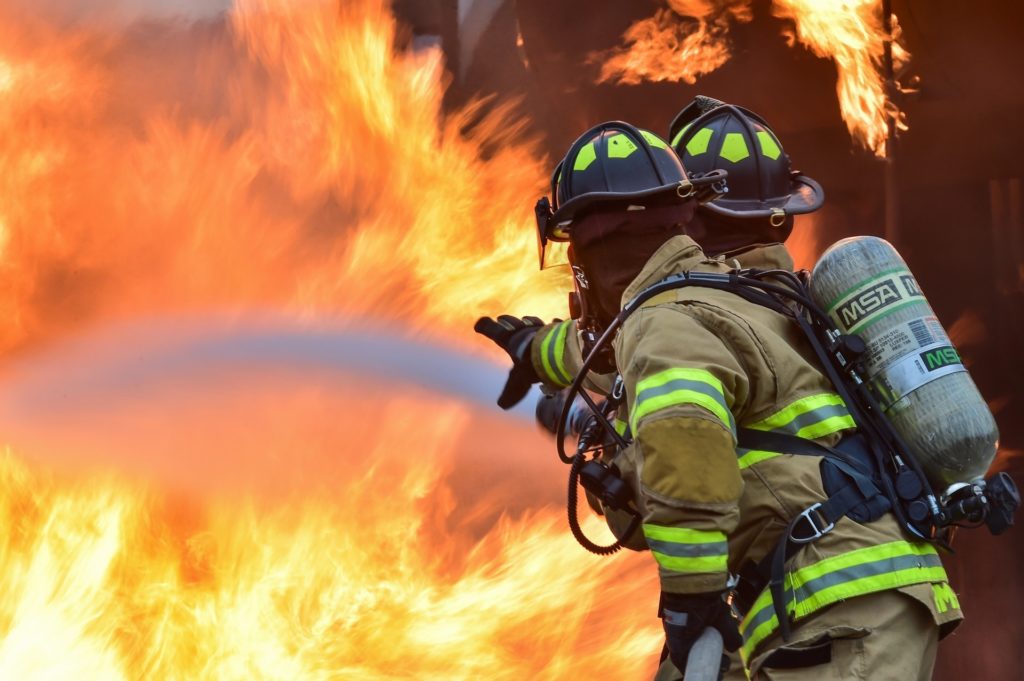 Two firefighters putting out a fire