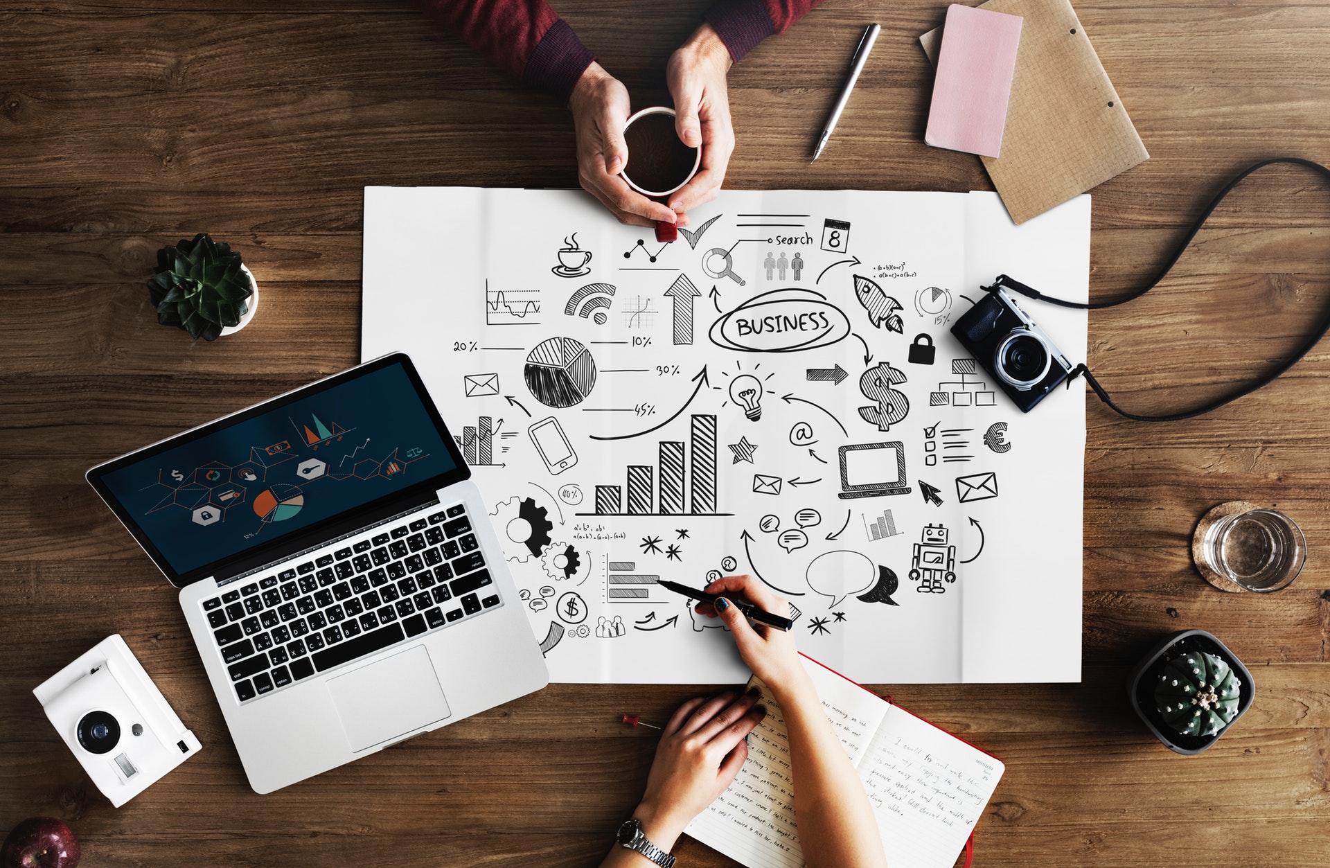 Laptop and business plan on table