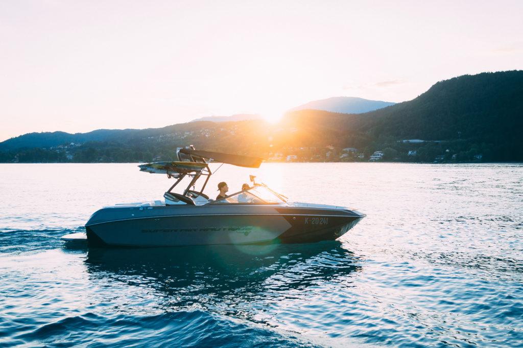 A motorboat at sunset in the summer.