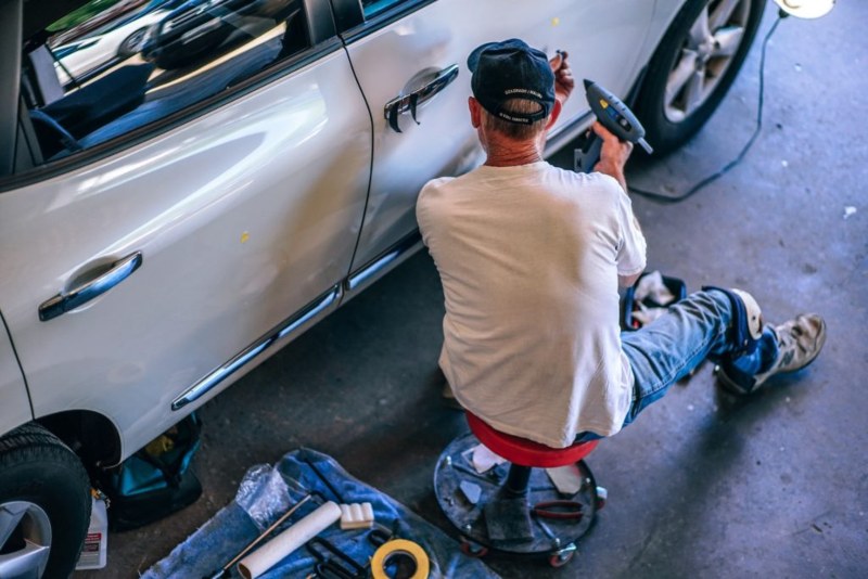 The man installing the door for car in Abbotsford BC