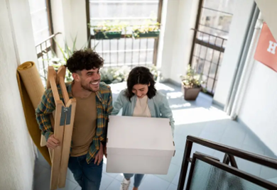 A happy couple moving in with renters' insurance in British Columbia