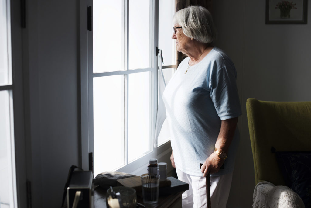 Senior woman standing alone at home