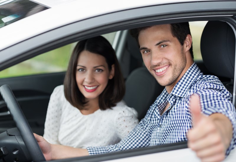 Smiling couple driving in a car