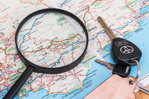 Keys and magnifying glass on map