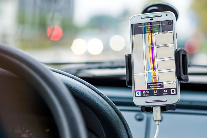 Phone using navigation app in car phone holder