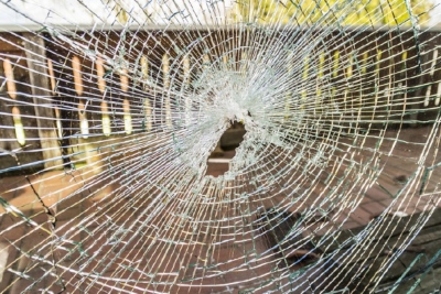 Shattered window showcasing need for home insurance in British Columbia, Canada