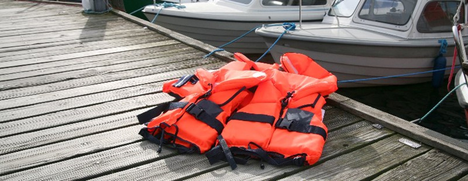 Two life jackets on a dock by Johnston Meier Insurance Agencies Group